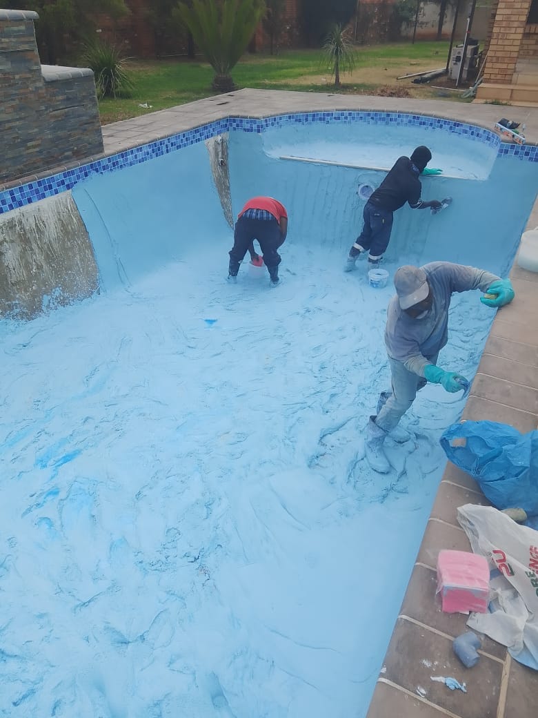 The inside of a new pool being hand-plastered